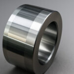 Cylindrical metal component with dual surface finishes on smooth gray background